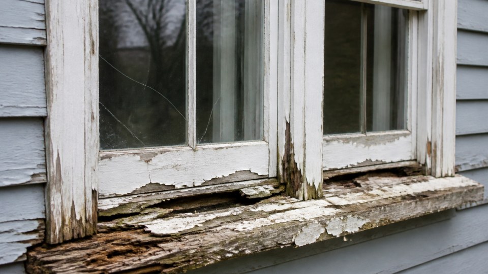 Aging Connecticut double-hung windows showing seal failure and draft gaps